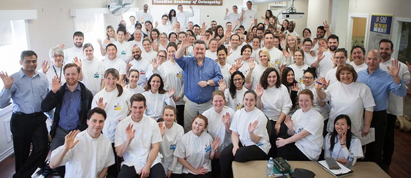 Students of the CAO along with Principal Robert Johnston and faculty gather for a group photo in a CAO laboratory classroom
