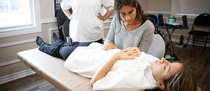 Student of the CAO practicing manual osteopathic care on a fellow student in the CAO student clinic